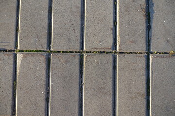 Close shot of stack bond brick like gray concrete pavement