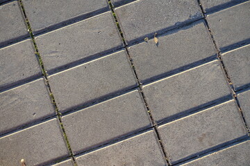 Top view of stack bond brick like gray concrete pavement