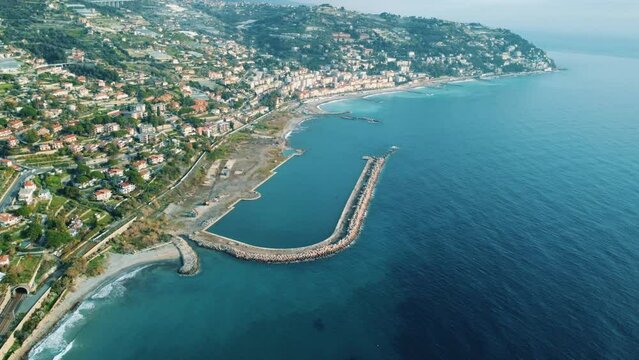 Epic aerial drone shot view of Ospedaletti a beautiful town on the ligurian riviera near San Remo in Italy. 