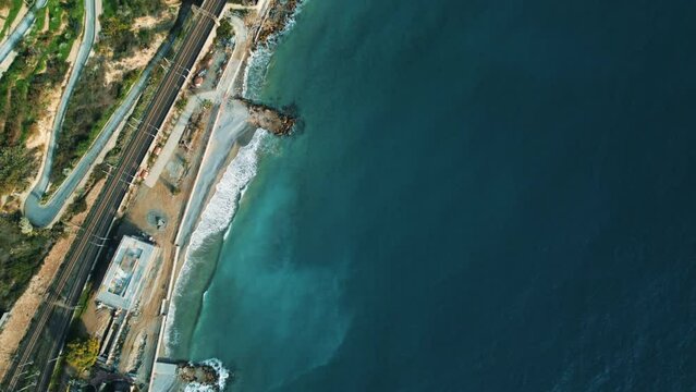 Epic aerial drone shot view of Ospedaletti a beautiful town on the ligurian riviera near San Remo in Italy. 