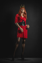 Fototapeta premium Luxury woman mannequin in red dress with golden crown on the head.