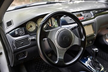 Car steering wheel and car sensors, inerior background, modern city car elements close view. Car...