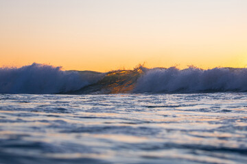 Morning breaking wave in the ocean.