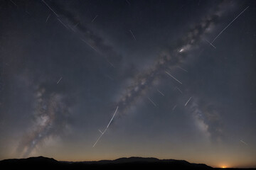 Naklejka na ściany i meble meteor showers streaking across the sky to evoke a sense of movement and cosmic activity