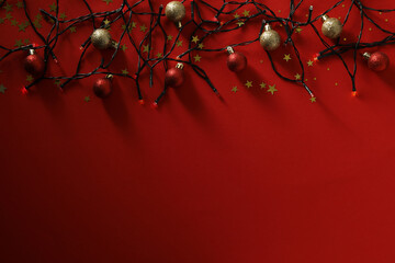 Christmas lights and balls on red background, space for text - obrazy, fototapety, plakaty