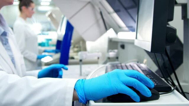 A medical research laboratory with a diverse team of biochemical scientists working with computers and modern medical technologies. Development of high-tech equipment for medicines.