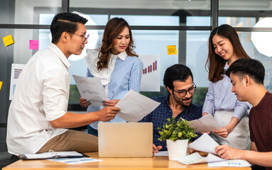 Group of creative asian business meeting and discussing strategy startup project analysis finance process.Success asian business work plan and brainstorm marketing idea with laptop in office.Teamwork