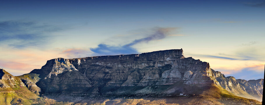 Copy space with scenic landscape of Table Mountain in Cape Town with cloudy blue sky background. Steep rocky mountainside with green valley. Breathtaking and magnificent views of the beauty in nature