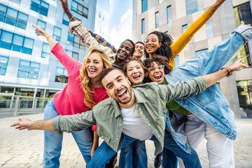 Multi ethnic friends having fun on city street - Youth community concept with group of young people smiling together at camera - University students standing in college campus - Bright filter - obrazy, fototapety, plakaty
