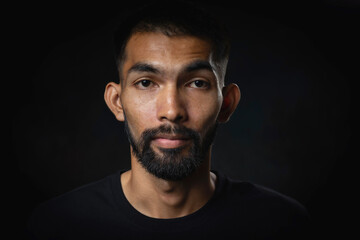 Close up shot of young men with beard and mustache in studio black background