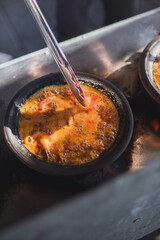 Hot plate or Sambal Gami is Traditional food from Indonesia. Served on plate with a bowl of rice and vegetables top view. Super hot and spicy food