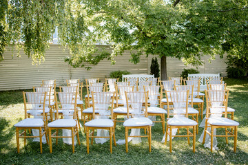 Flower decoration for celebrations. Decoration of tables and chairs. Rustic decoration.