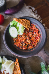 Hot plate or Sambal Gami is Traditional food from Indonesia. Served on plate with a bowl of rice and vegetables top view. Super hot and spicy food