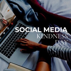 Low section of asian woman in red socks using laptop on bed and social media kindness day text