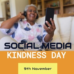 Biracial senior woman video calling over phone and social media kindness day, 9th november