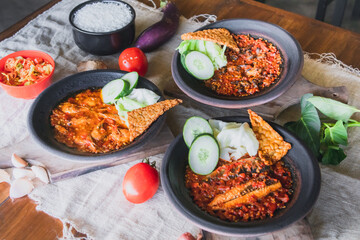 Hot plate or Sambal Gami is Traditional food from Indonesia. Served on plate with a bowl of rice and vegetables top view. Super hot and spicy food