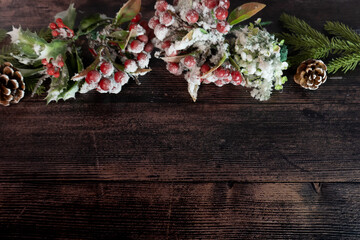 New Year or New Year's Eve on a wooden background of fir branches, cones and amelia. The year 2024 is approaching.