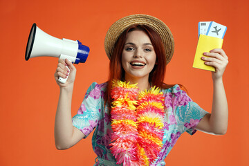 Close up of happy woman holding megaphone and flight tickets with passport, smiling looking at the...