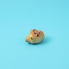 Homemade roll kifla on blue background. Fresh baked. Pastry concept. 