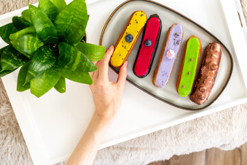 Many eclairs with different flavors. Sweet food background