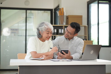 African Asian business man and woman successfully working and talking on the phone with customers