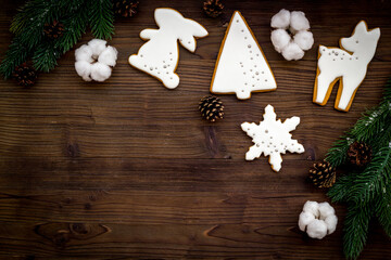 New Year decoration - white Christmas cookies with fir tree branches, top view