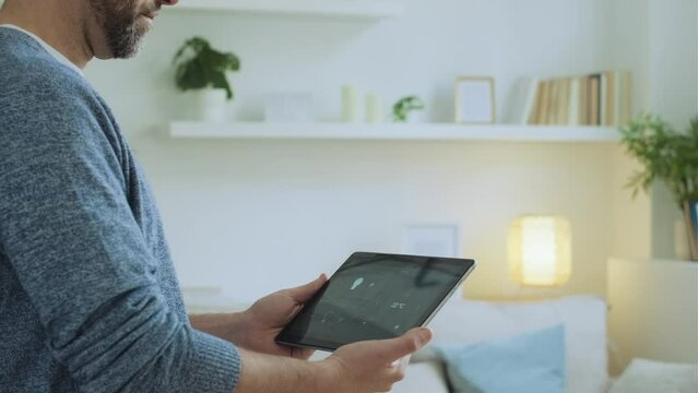Man using digutal laptop as smart home control
