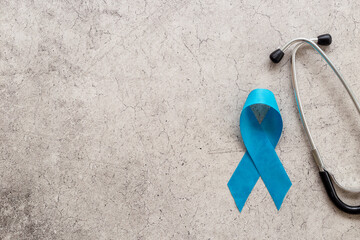 Blue ribbon symbol of prostate or colon cancer awareness concept