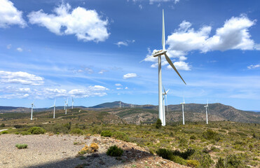 Wind turbine in mountains landscape. Eolic park windpower. Wind farm, New Wind green energy. Wind turbines alternative energy. Windmill power clean electricity generation. Spain Windfarm in Castellon
