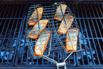 Delicious grilled salmon fillet steak in prepared grill with flames