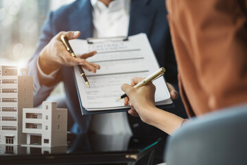 Real estate broker agent presenting and consult to customer to decision making sign insurance form...