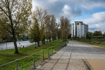 Fototapeta premium Anderlecht, Brussels Capital Region, Belgium - Cycling path and trees at the banks of the canal