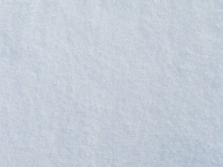 Natural snow texture. Smooth surface of clean fresh snow. Snowy ground. Winter background with snow patterns. Perfect for Christmas and New Year design. Closeup top view.