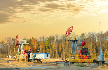Oil prices on global market. Crude oil Pumpjack on oilfield on sunset. Fossil crude production. Oil...
