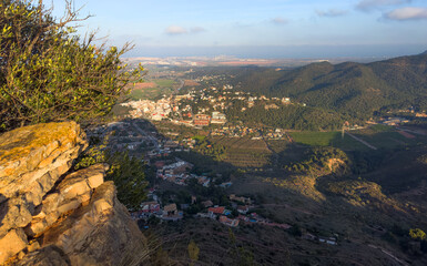 Houses at Gilet Town in mountains. Urbanization with houses and homes in mountains hills. View on city from mountain. Rural landscape with hills. Spain mountains landscape in Sierra Calderona park.