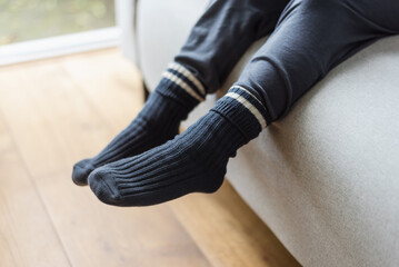 View of the feet of a small child in warm knitted socks.