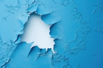 torn ripped hole on a blue paper background
