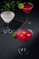 martini glasses of red and coconut alcohol drinks