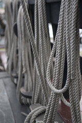 Ship ropes coiled into rings on board a sailing ship - 671571563
