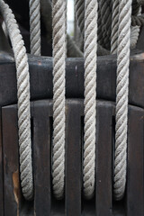 Ship ropes in a block on the mast of a sailing ship - 671571701