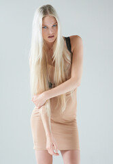 Obraz premium Woman, classy fashion and portrait with modern style, beauty and confidence in a studio. Grey background, female person and model from Russia with trendy clothing and youth with elegance and dress