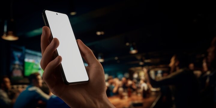 CU Caucasian man using phone inside a sports bar, online betting, bookmaker