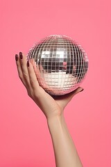 Creative contemporary collage of woman hand holding disco ball on pink background. Concept of...