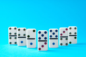 Domino tiles on blue background studio shot