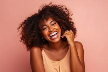 Joyful African woman laughing heartily.