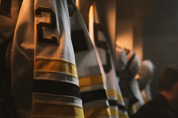 ECU View of ice hockey team uniform hanging in a changing room - obrazy, fototapety, plakaty