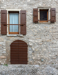 Fototapeta na wymiar door and windows on stone wall