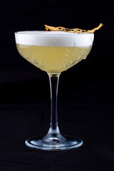 A deliciously cocktail with pear liqueur. Isolated on a dark background