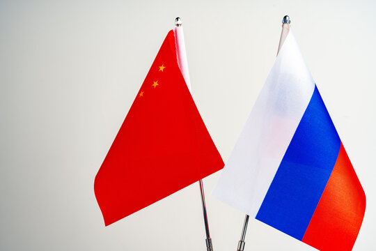 Russian and Chinese flags on negotiation table