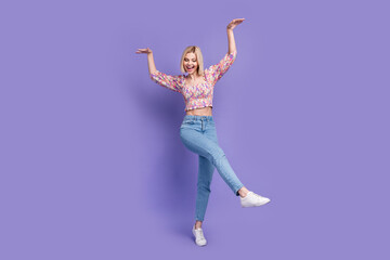 Full body portrait of gorgeous overjoyed lady have good mood dancing chilling isolated on purple color background